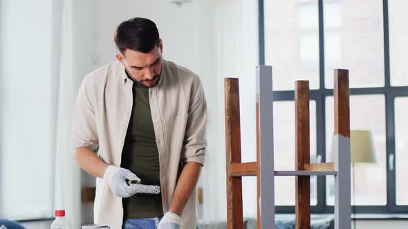 Man Painting Old Table in Grey Color at Home