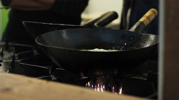 Cook Boiling in Black Pan
