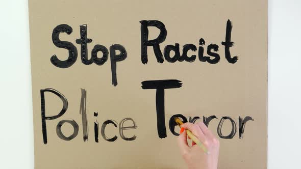 Timelapse. Close-up, Hand Writes Slogan - Stop Racist Police Terror - with Brush, Using Black Paint