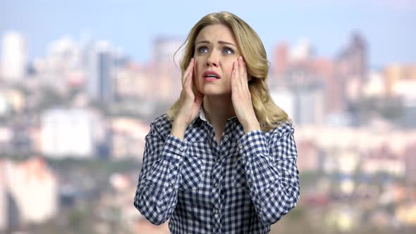 Depressed Young Woman Holding Hands on Head.