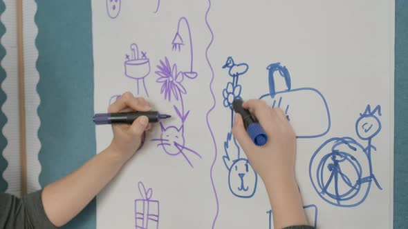 Teacher and pupil painting symbols on paper