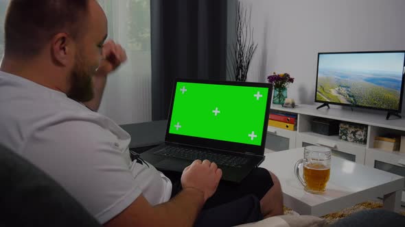 Man Using Laptop with Greenscreen and Chroma Key.