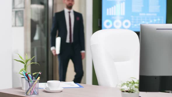 Male in Business Suit Enters the Office