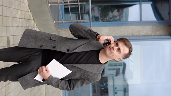 Elegant Smiling Businessman Talking on the Phone on Street