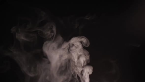 White smoke, fog, mist, vapor on a black background.