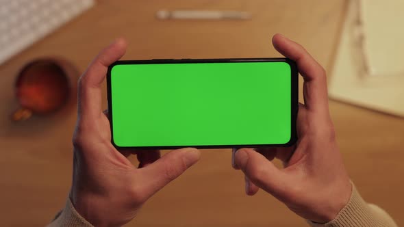 Close Up of Smartphone with Chroma Key Screen in Male Hands