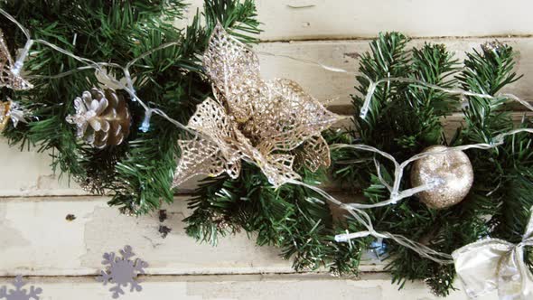 Wreath with christmas decoration on a plank