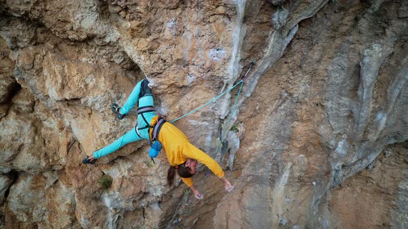 Slow Motion Back View Man Rockclimber Climbs on Overhanging Crag