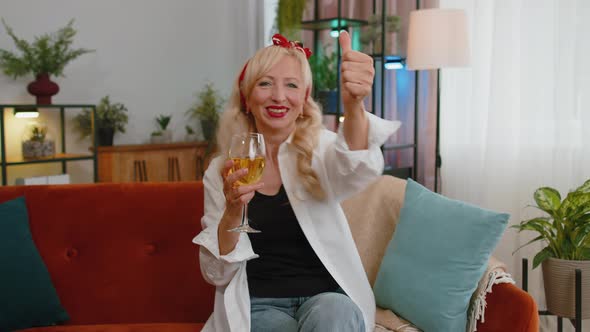 Joyful Senior Old Grandmother Hold Glass of Champagne Cheering Drinking Celebrating Success Win