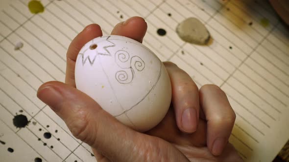 Female Craftsman Hands Creating Easter Egg