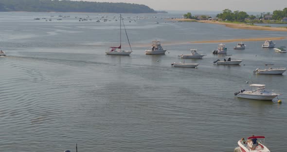 Top Down Aerial View of a Speed Boat Passing Near a Pier in Cold Spring Harbor