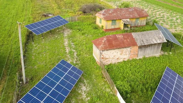 Aerial top down view of solar panels in green rural area.