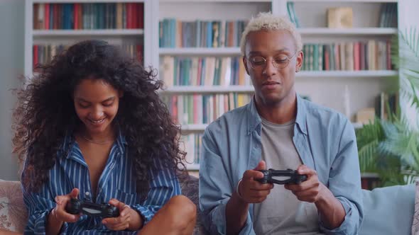 Interracial Young Indian Woman and African American Man Playing Video Games