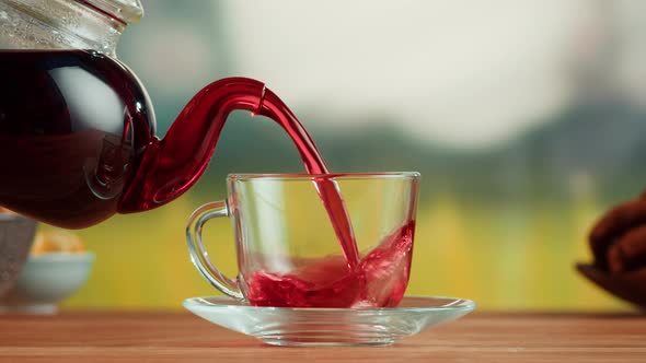 Pouring Red Fruit Tea Into Glass Cup Closeup