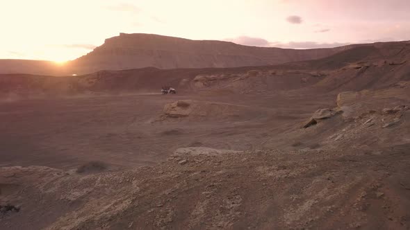 Aerial view flying towards OHV driving in the desert