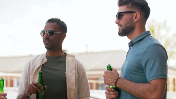 Happy Male Friends Drinking Beer at Rooftop Party