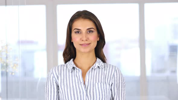 Portrait of Young Hispanic Woman Shaking Head to Accept, Yes