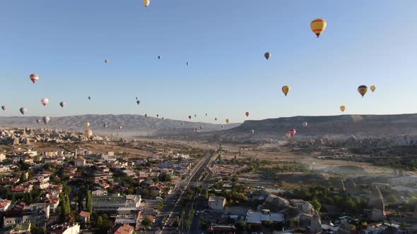 Hot air balloons flying over the valleys of Cappadocia near Goreme, Turkey