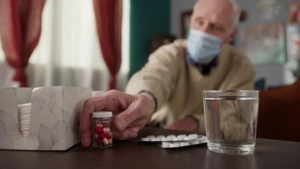 Old Man Hold Many Multicolored Pills in a Senior's Hands Antibiotic and Vitamin Drugs