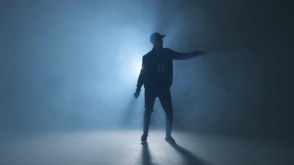 A Dark Silhouette of a Singer on the Stage Dancing Alone During Performance