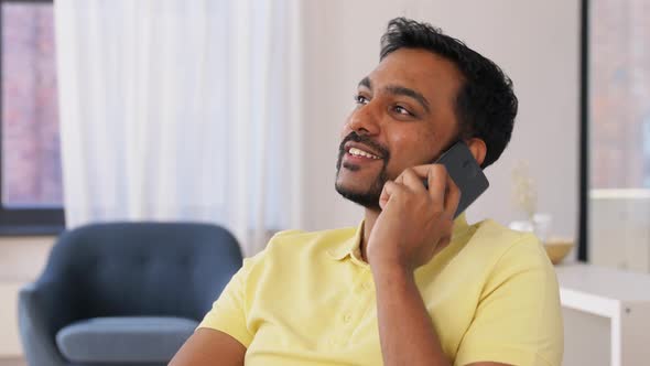 Happy Man Calling on Smartphone at Home Office