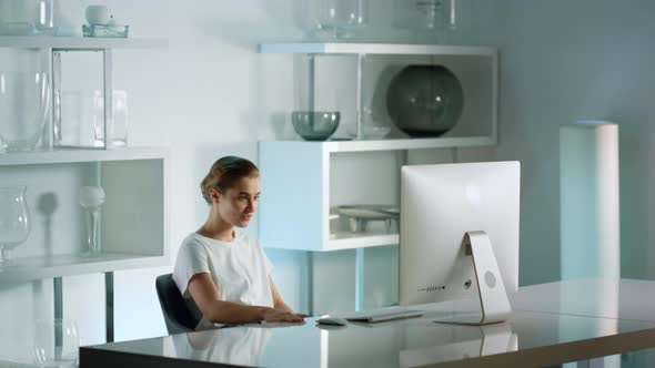 Smiling Businesswoman Talking Online with Friend Leaning Chair After Hard Day