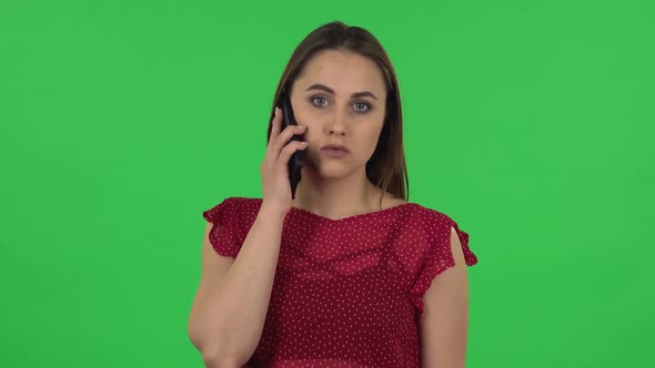 Portrait of Tender Girl in Red Dress Is Talking for Mobile. Green Screen
