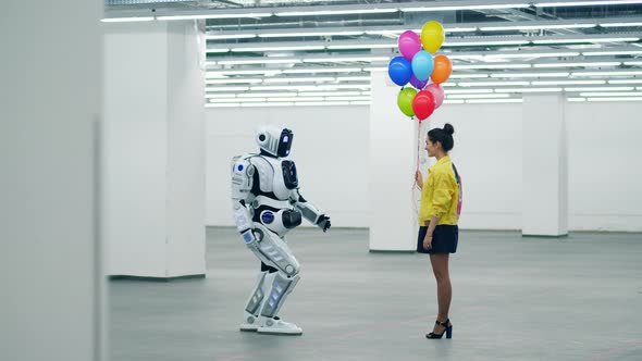 A Girl Is Giving Balloons To a Cyborg in an Empty Hall