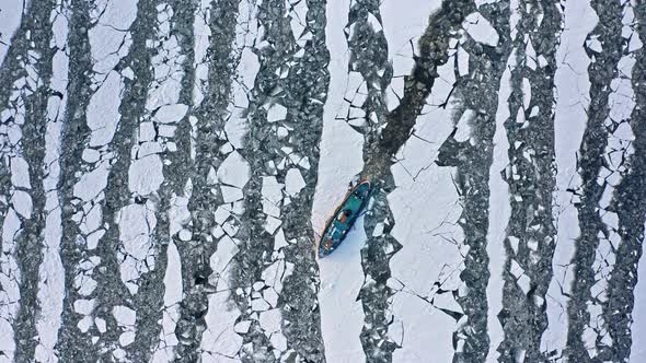 Icebreaker on Vistula river crushing the ice, Poland. Aerial view.