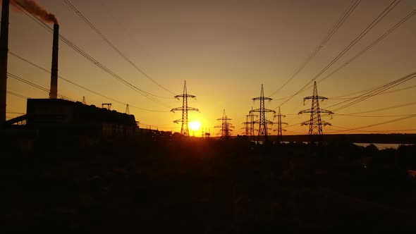 Electric tower of high voltage. Aerial view of high voltage power lines silhouette