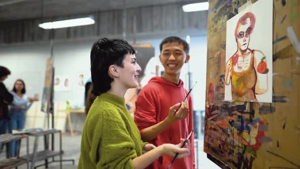 Young students painting on canvas during lesson in faculty of arts university