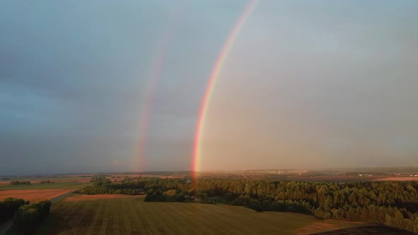 Dark Thunderstorm Clouds and Double Rainbow Over Forest and Wheat Field, Areal Dron Shoot.