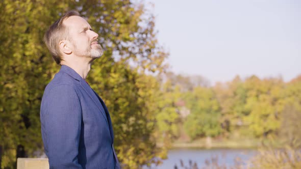 A Middleaged Handsome Caucasian Man Thinks About Something in a Park in Fall