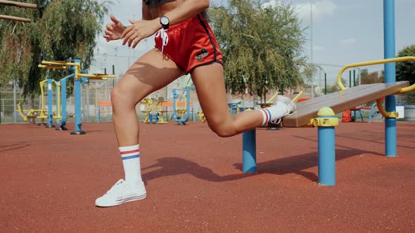 Sporty Beautiful Woman with Long Black Hair Doing Split Squat on the Street