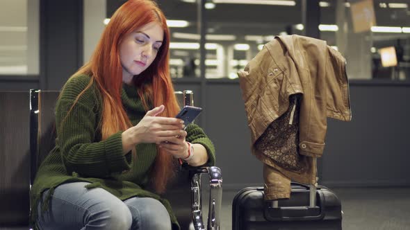 Female Is Waiting for Delayed Flight at Night Airport