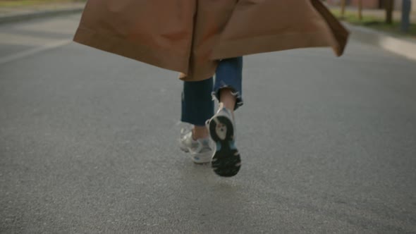 Rare View Shot of Casual Woman Running on Street