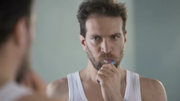 Completely Unhappy With His Life Man Cleaning Teeth and Thinking About Changes