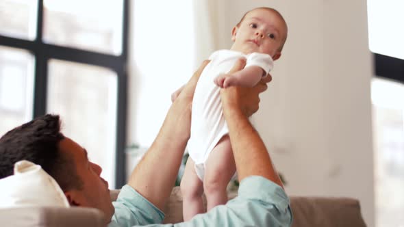 Middle Aged Father with Baby Daughter at Home