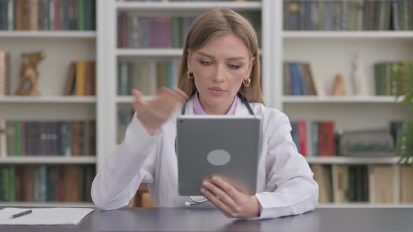 Lady Doctor Doing Video Chat on Tablet in Clinic