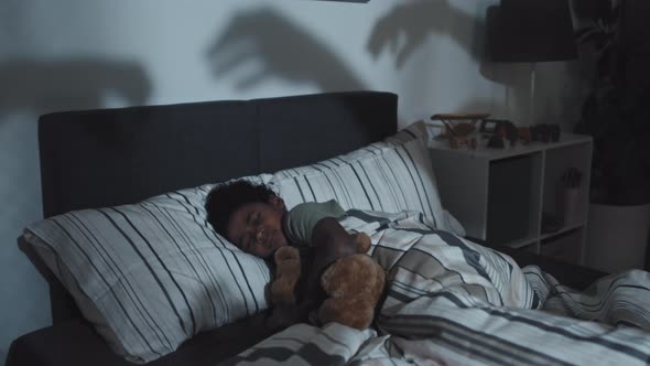 Hands Shadows Reaching for Sleeping Boy