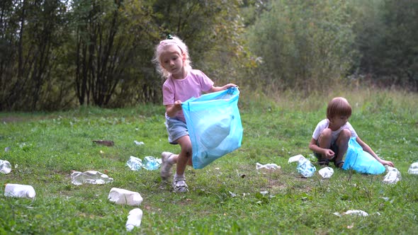 Children Remove Plastic Garbage and Put It in a Biodegradable Garbage Bag in the Open Air