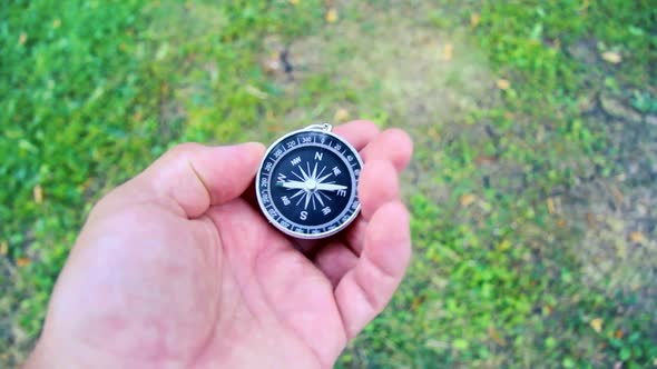 Search for the cardinal points with a compass. Compass in hand.