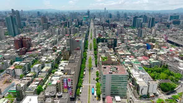 Aerial flyover Zhongxiao Donglu avenue with traffic in downtown of Taipei City during sunny day,Taiw