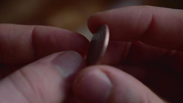 Coin is flipped in the air by hand of man in coin toss 20