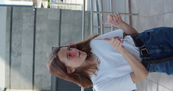 Vertical Close View of Girl in Stylish Look Dancing in Front of Camera Outdoors