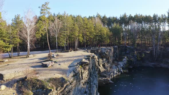 Aerial View Alone Man Walking Along Edge of Cliff