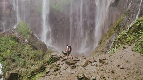 Happy Backpacker Hiking in Rainforest Forest Near Waterfall