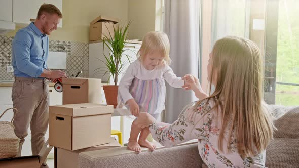 Active Family Group Move in Rent Real Estate. Positive Looking at Relocating or Unpacking of Carton