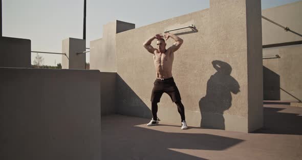 Sportsman Doing Jumping Jacks on Sports Ground