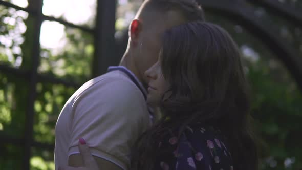 Young Beautiful Couple Hugging on Sunset Background